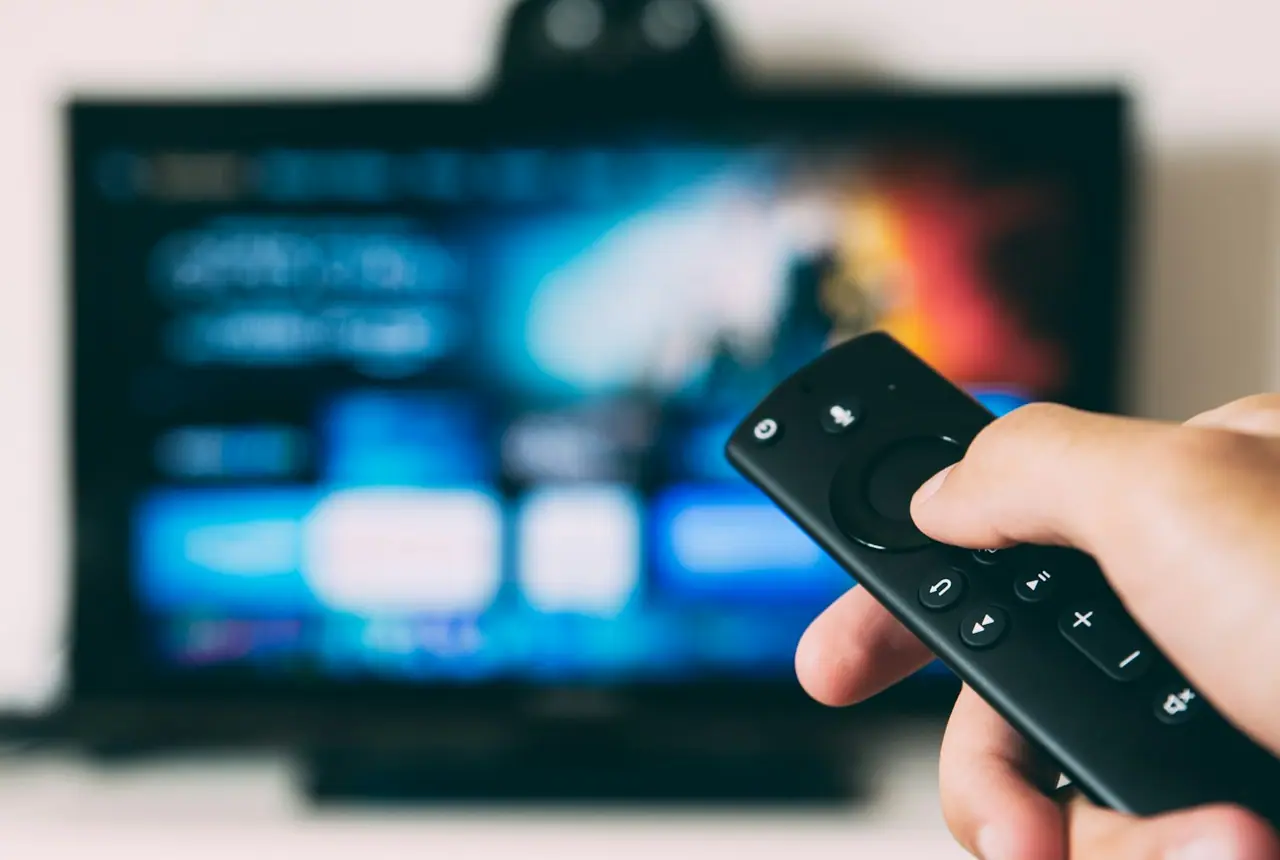 Premium IPTV streaming interface on a television with remote control